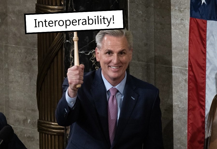 Modified image of Kevin McCarthy holding a sign that says Interoperability in place of the Speaker's gavel